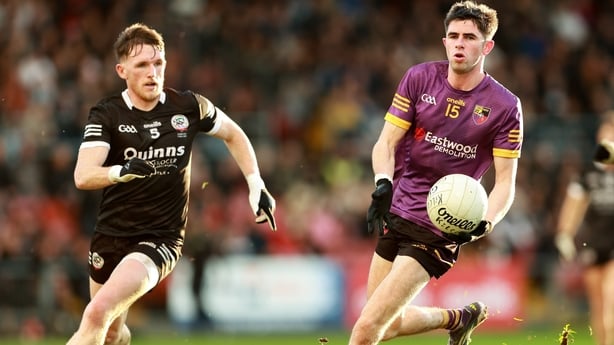 19 October 2025; John McGeough of Carryduff in action against Miceal Rooney of Kilcoo during the Down County Senior Club Football Championship final match between Carryduff and Kilcoo at Páirc Esler in Newry, Down. Photo by Thomas Flinkow/Sportsfile