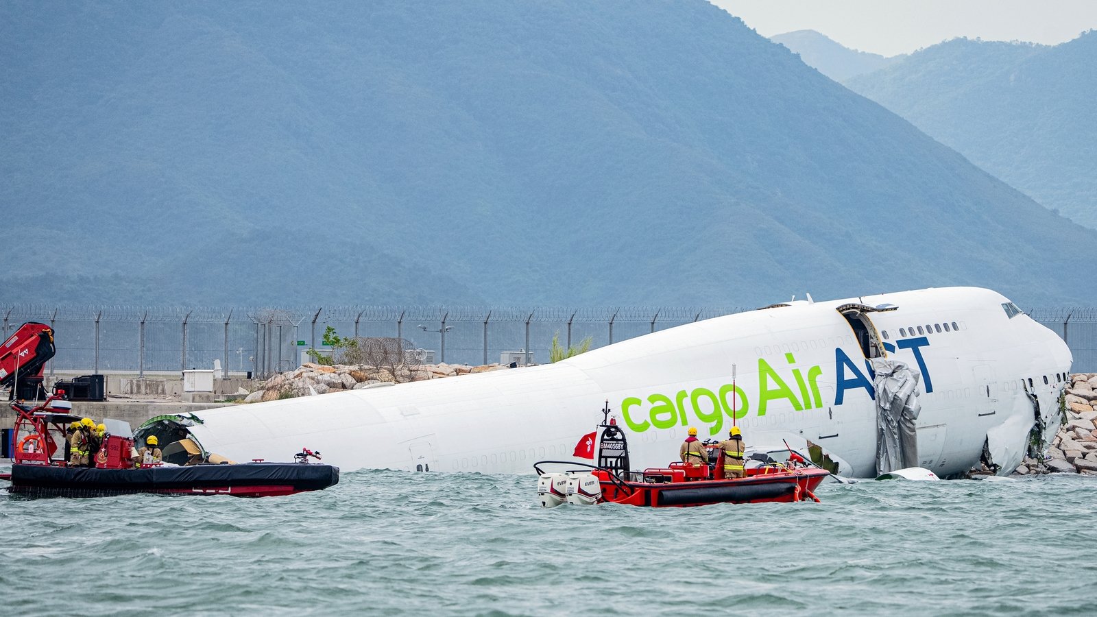 Two killed as cargo plane skids off Hong Kong runway