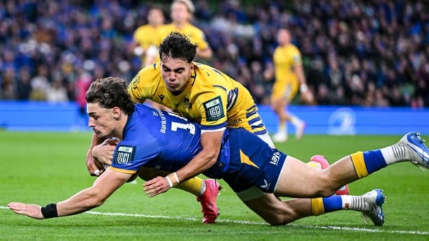 25 October 2025; Joshua Kenny of Leinster dives over to score his side's first try despite the tackle of Mirko Belloni of Zebre Parma before the United Rugby Championship match between Leinster and Zebre Parma at the Aviva Stadium in Dublin. Photo by Brendan Moran/Sportsfile