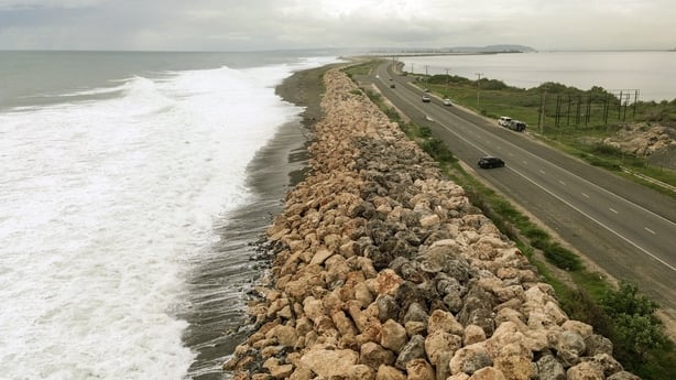 This aerial view shows storm surge crashing into the seawall that protects Palisadoes Strip, the route to Norman Manley International Airport, before the arrival of Hurricane Melissa