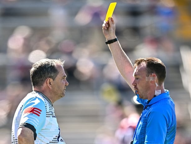17 May 2025; Antrim manager Davy Fitzgerald is shown the yellow card by referee Thomas Gleeson during the Leinster GAA Hurling Senior Championship Round 4 match between Galway and Antrim at Pearse Stadium in Galway. Photo by Piaras Ó Mídheach/Sportsfile
