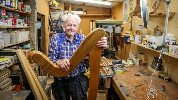 89 year old Harp maker Noel Anderson poses for a portrait at his home workshop in Strabane