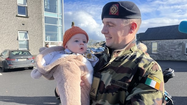 An image of Defence Forces member Conor Hurley holding his 5 month old son Lú 