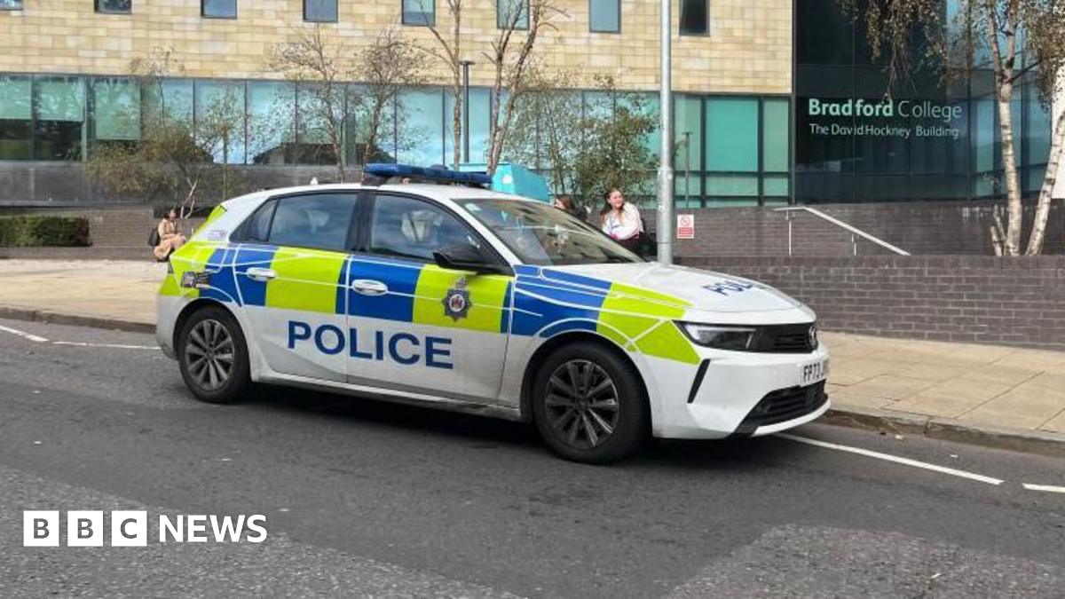 Police car parked at the scene outside Bradford College on Great Horton Road.