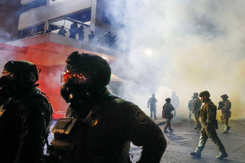 Federal agents deploy tear gas as demonstrators gather at Portland's ICE facility on October 18.