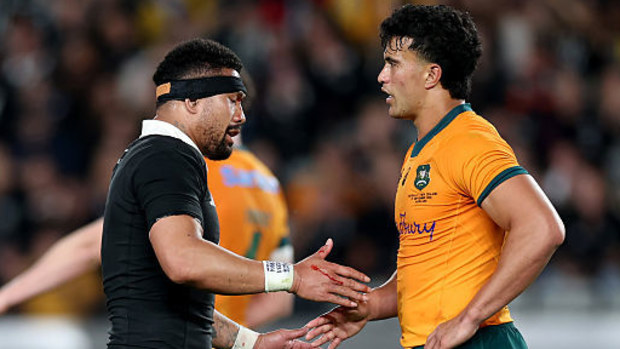 Ardie Savea of New Zealand and Joseph-Aukuso Suaalii of Australia shake hands.