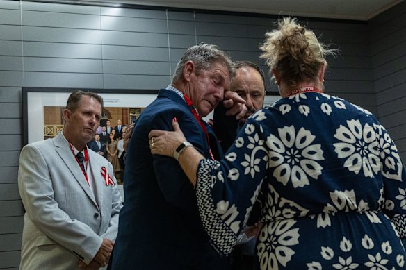 Paul Grimmer, Jeremy Buckingham and Grimmer family members embraced and comforted each other outside following their statement in Parliament on Thursday.