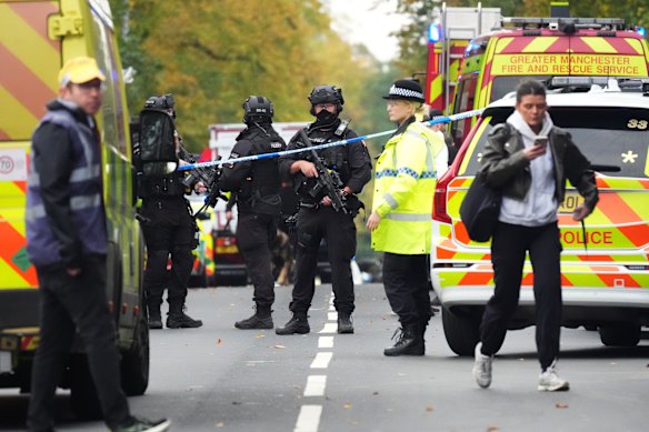 Armed Police, emergency responders and congregants gather near the Heaton Park Hebrew Congregation Synagogue, where multiple were injured after stabbing and car attack on Yom Kippur.
