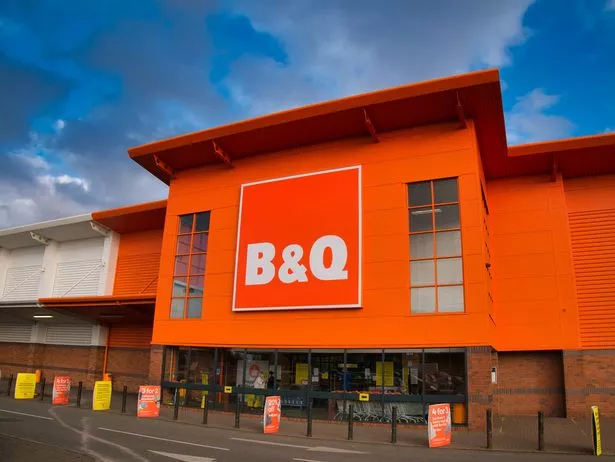 The frontage and brand logo of a branch of the UK DIY store B&Q, taken in a local retail park on Wirral, UK on a sunny afternoon