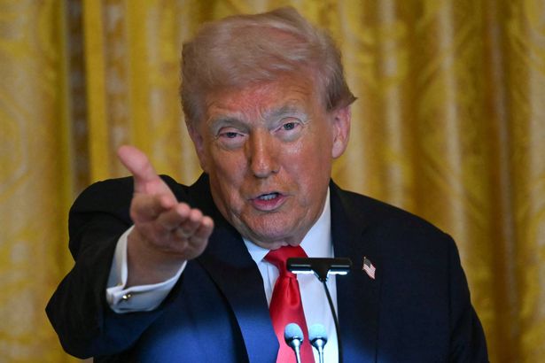 US President Donald Trump gestures as he speaks during a dinner with ballroom donors in the East Room of the White House