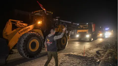EPA/Shutterstock Equipment and personnel under the supervision of the Egyptian committee cross into the Gaza Strip through the Kerem Abu Salem crossing in Khan Yunis, southern Gaza Strip, 25 October 2025.