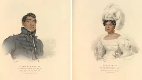 Trustees of the British Museum Sketches of a young Hawaiian man and women in fine 19th century clothing. On the left is the king wearing a dark grey military style jacket. He has short wavy hair and is posing, looking slightly upwards. The Queen is wearing a white plumed headdress and a square-necked white dress with fine ruffled neckline, puffed sleeved and the dress gathers in at the waistband and flares out in pleats. Her hair is gathered and you can only see some of her curled hair around her forehead and she wears earrings. 
