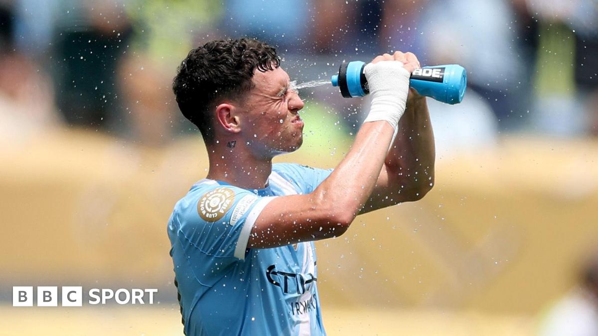 Phil Foden sprays water at his face during the Club World Cup