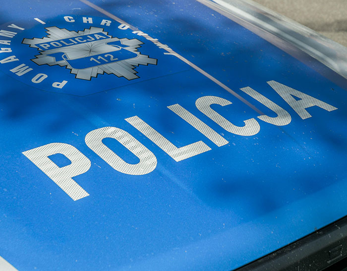 Close-up of a Polish police car hood indicating involvement in a teen missing 27 years case discovered at parents’ house.