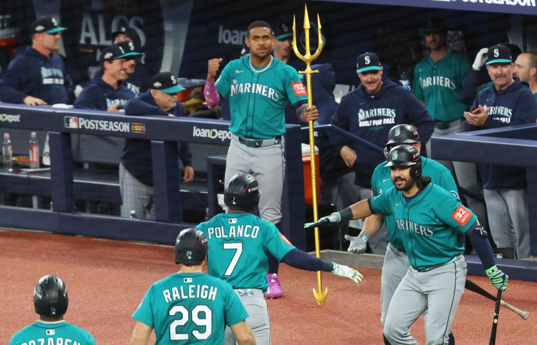 Mariners cheer on Mariners second baseman Jorge Polanco (7) after making a three run homer against Toronto Blue Jays in Game 2 of the American League Championship Series Monday, October. 13, 2025 at Rogers Centre, in Toronto, ON, Canada.