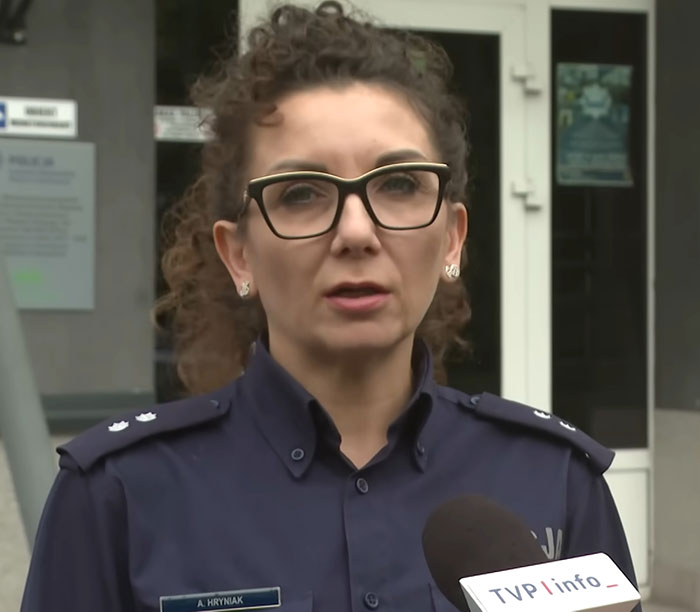 Police officer wearing glasses speaks outside a building about teen missing 27 years found in parents’ house in poor condition