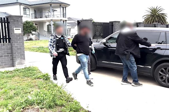 Taskforce Hawk detectives make an arrest on Thursday.