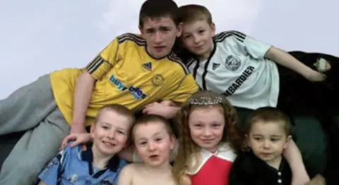 Supplied Children grouped together smiling for a family picture