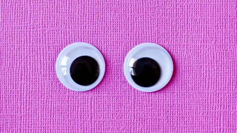Getty Images A pair of plastic googly eyes on a pink background
