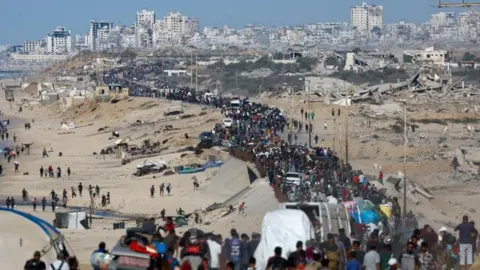 Reuters Palestinians walk north towards Gaza City
