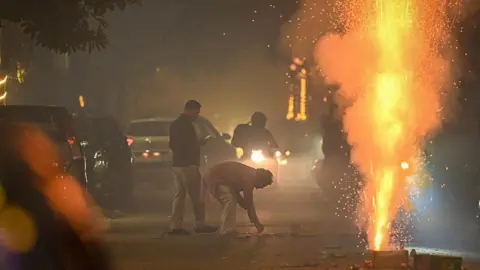 Hindustan Times via Getty Images People burst crackers to celebrate Diwali Festival at Patel Nagar on October 20, 2025 in New Delhi, India. 
