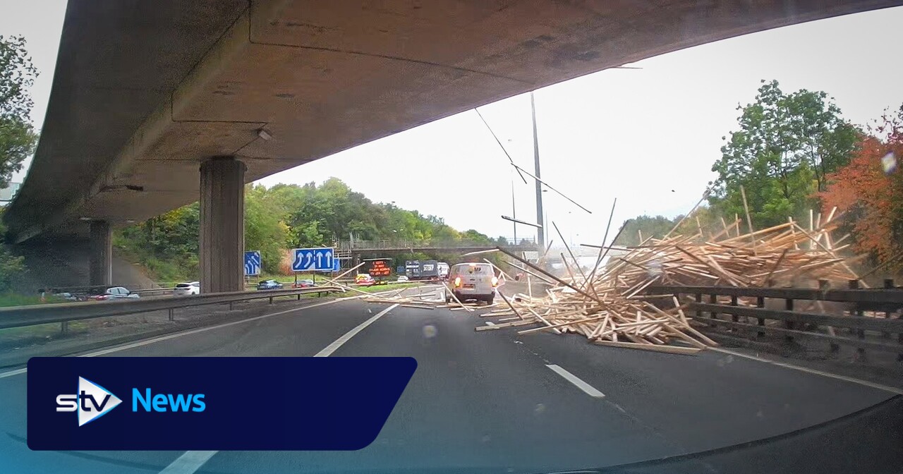 Lorry driver dies after trailer load of timber crashes onto M8 in Glasgow