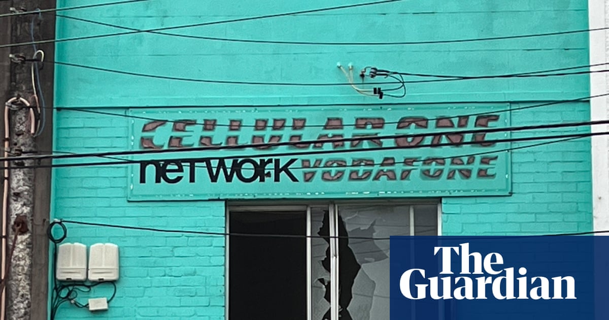 Man arrested after at least 50 shots fired from Sydney home injure bystanders, hit buildings and cars | Sydney