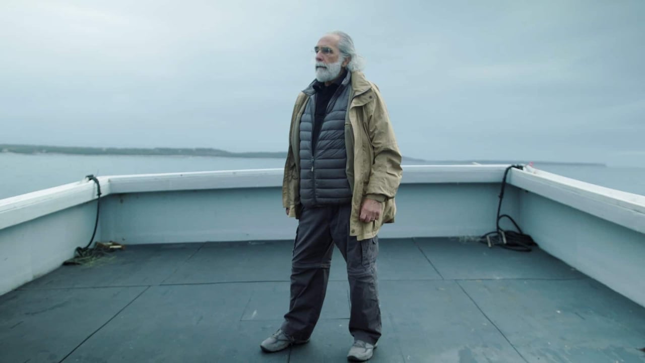 A man stands in a boat.