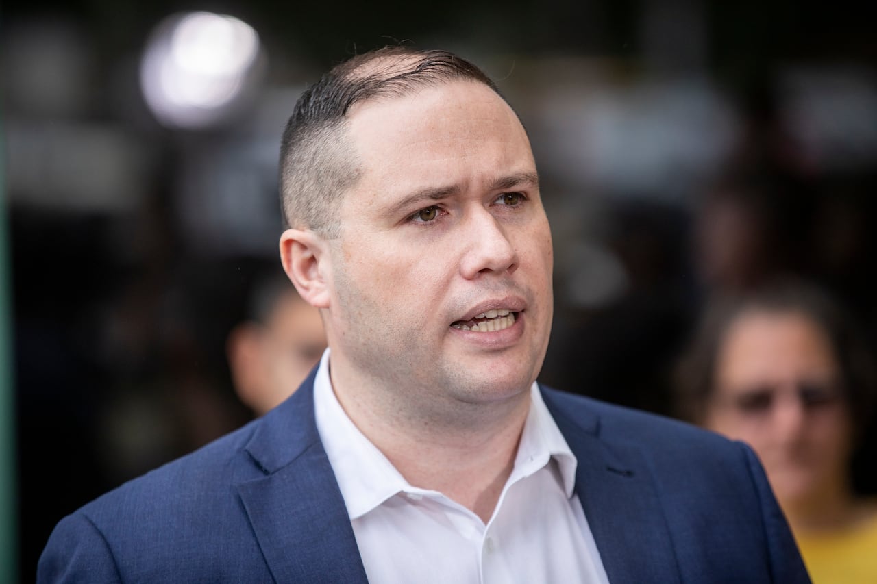 A man wearing a suit speaks.