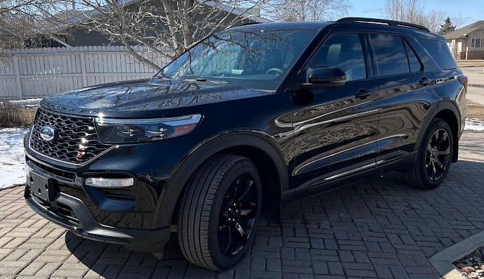 A black SUV parked on a driveway.