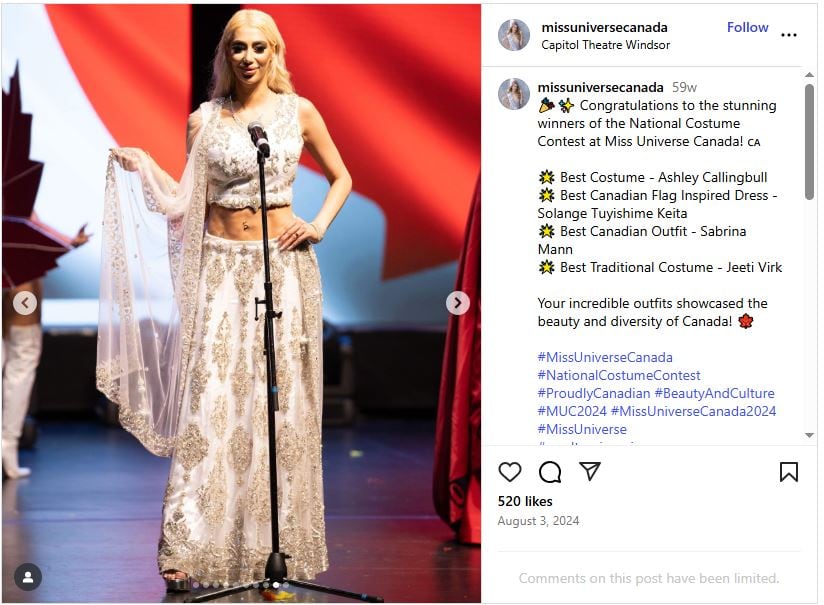 A woman in a south asian dress standing on a stage. 