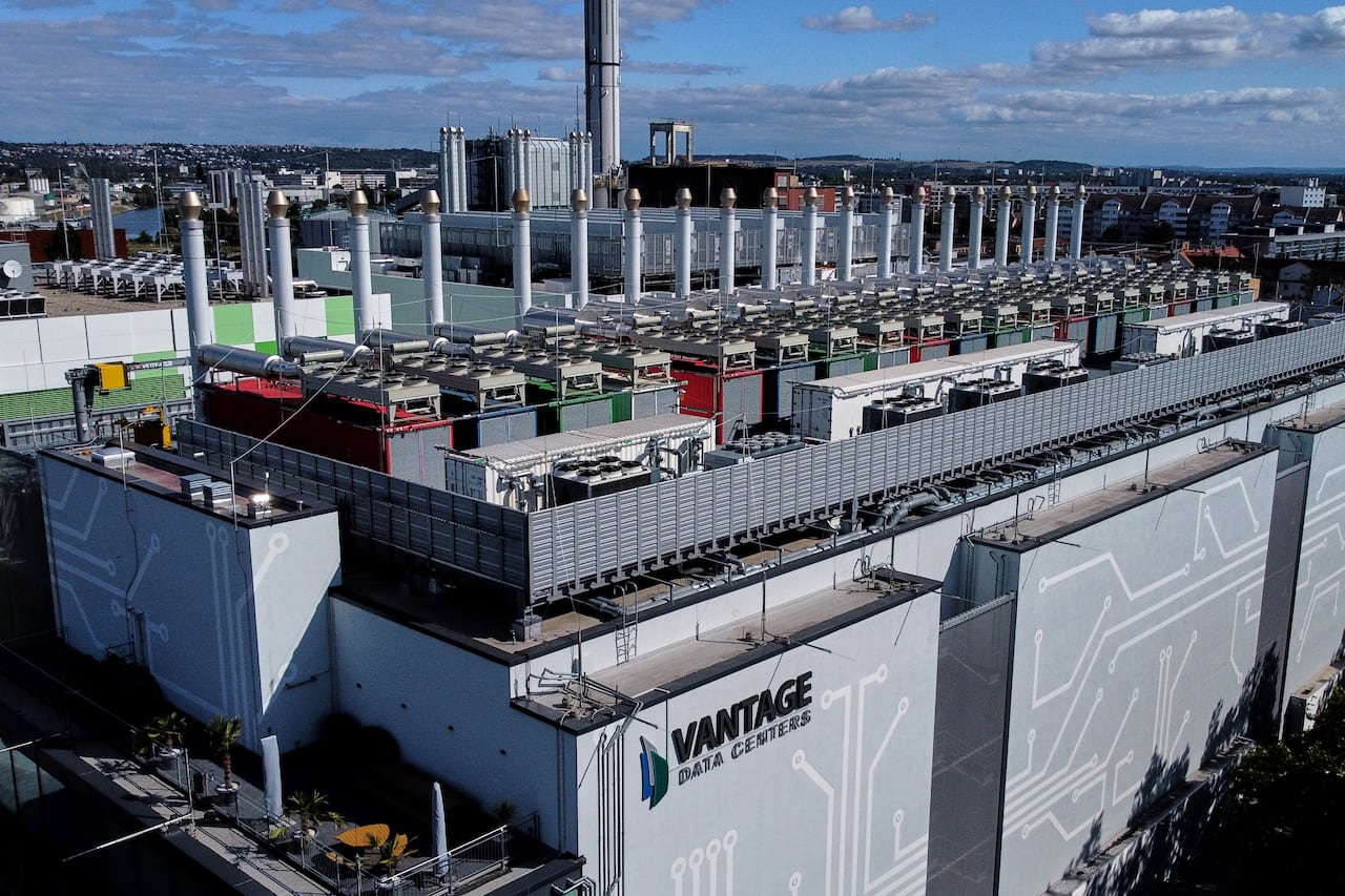 A big building with a bunch of towers. The building is named "Vantage Data Centers"