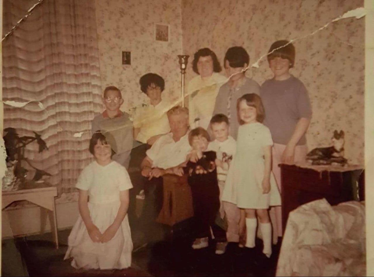 A large family poses in a room
