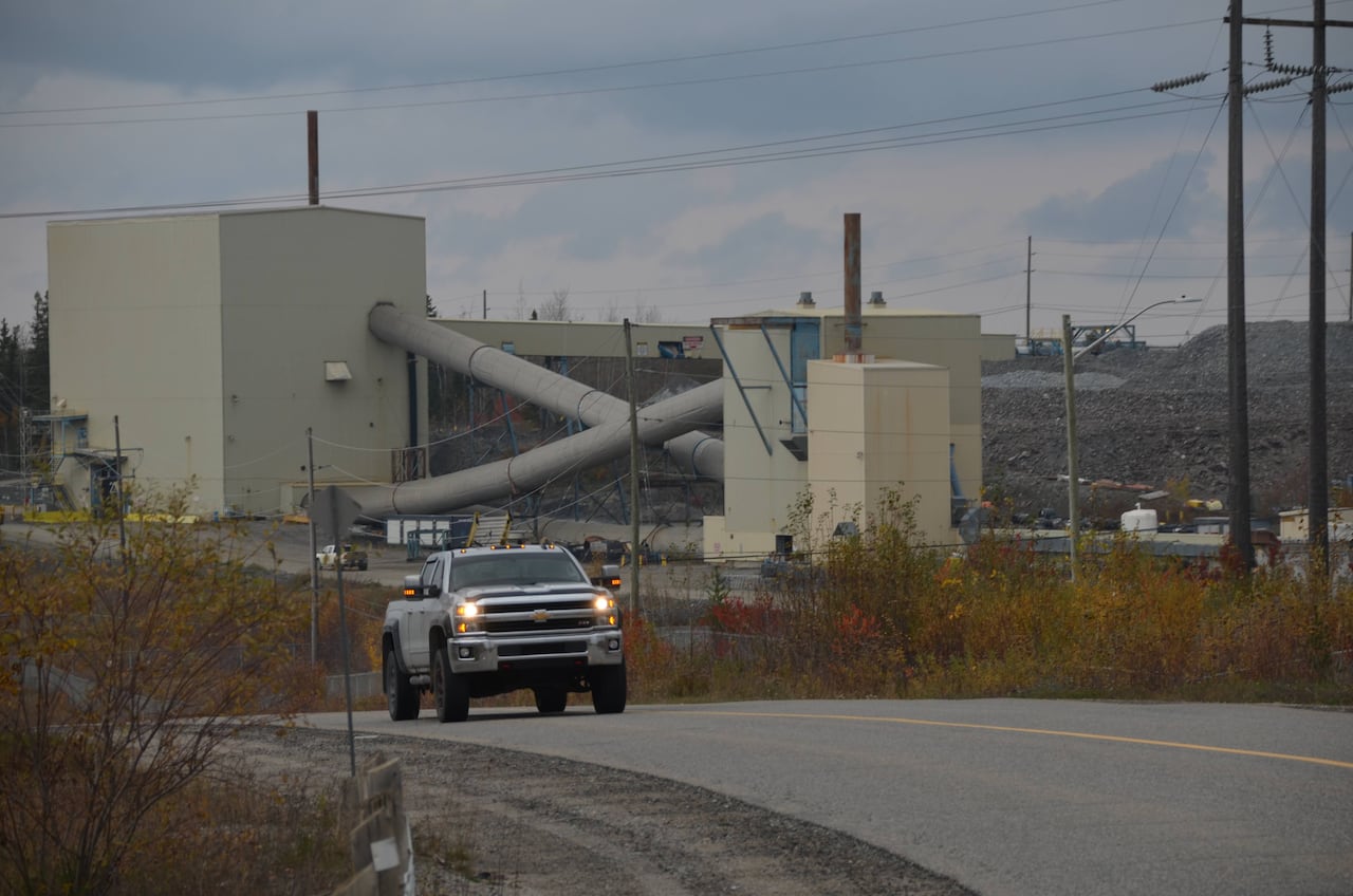 A truck drives past a mine 