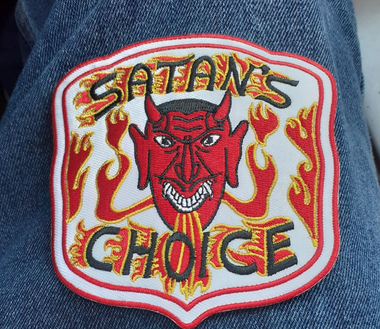 Photo of a Satan's Choice patch on jeans. 