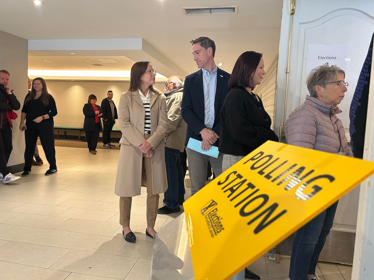 Man and woman looking at each other in line to vote