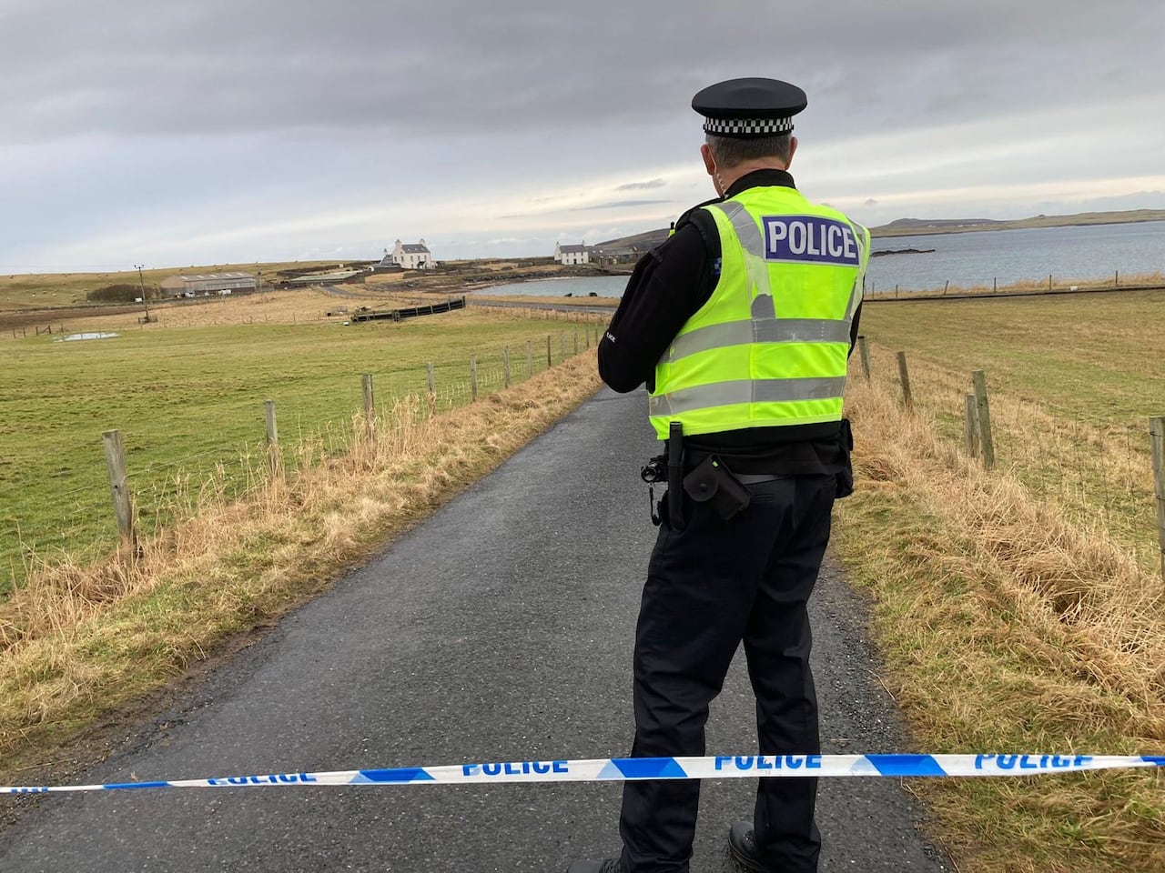 A police officer stands at a roadblock near Sandness, a village on Scotland's Shetland Islands, in February 2024.