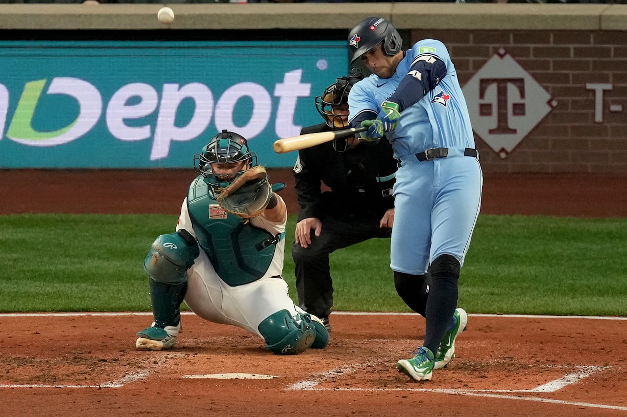 A baseball player's follow-through, with the ball coming off the bat