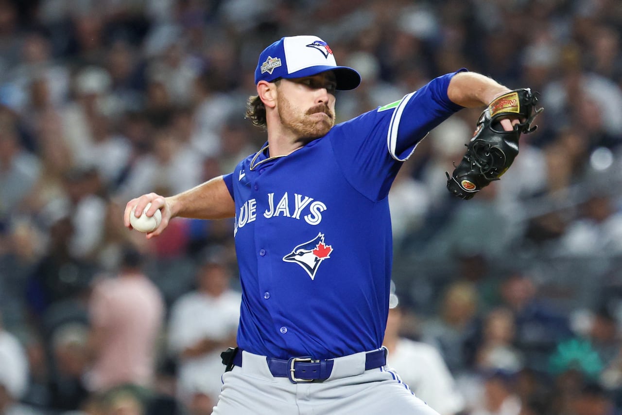 A baseball pitcher in the middle of his wind-up