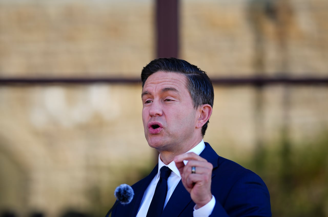 A man with dark hair gestures