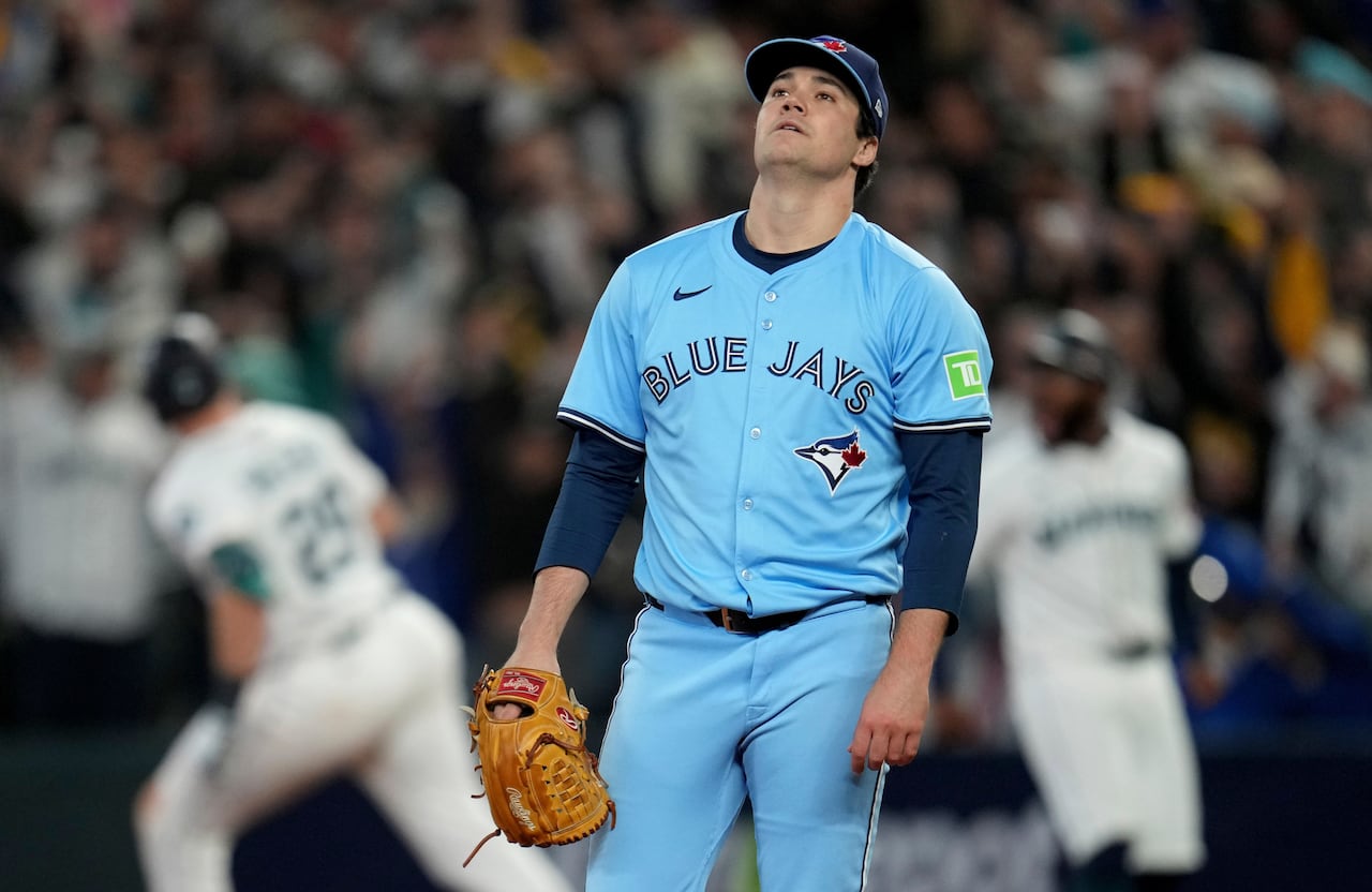 A man in a baseball uniform looks dejected. 