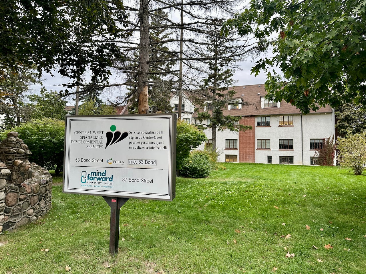 A large multi-storey house on Bond Street in Oakville with a sign for Central West Specialized Developmental Services.