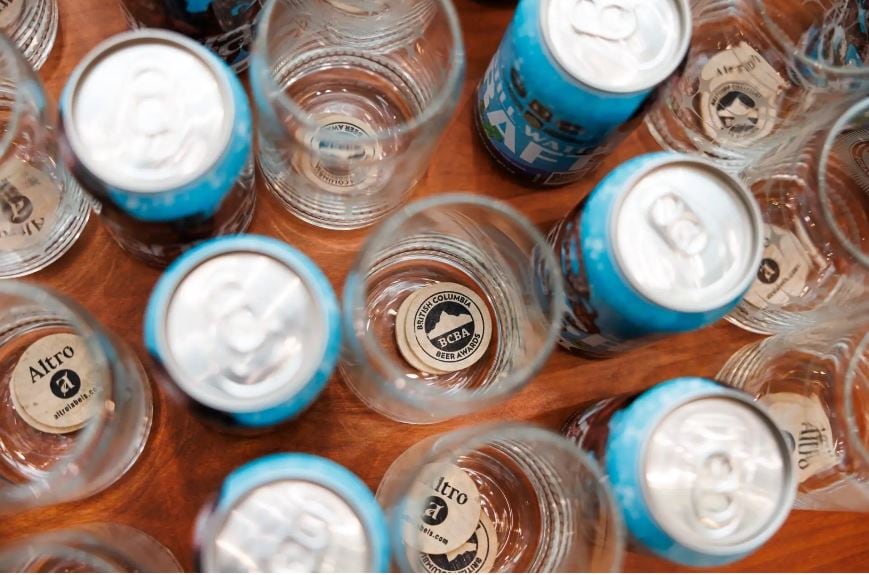 Beer cans and glasses pictured from above