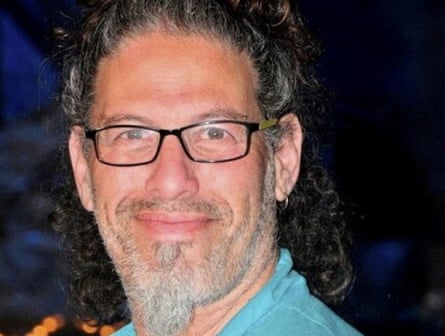 A man with glasses who is smiling