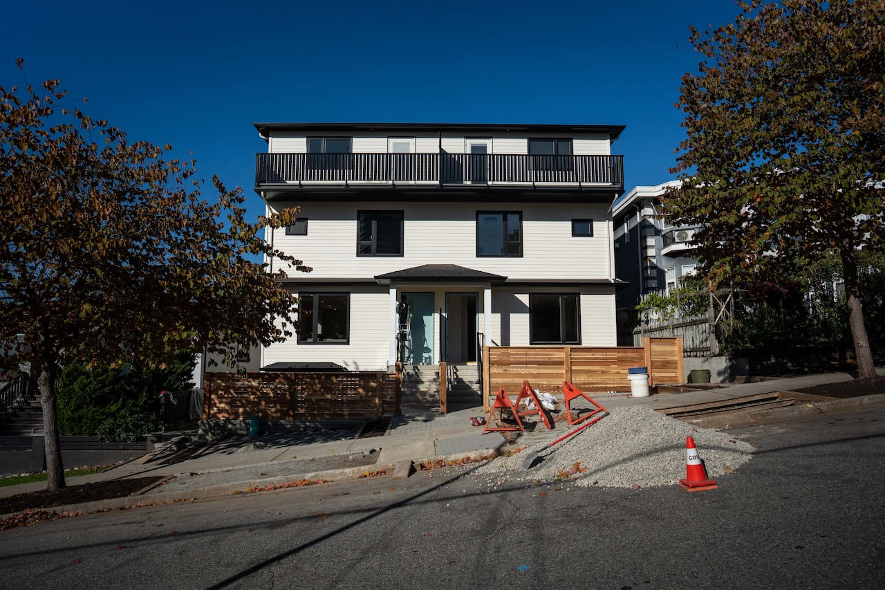 A finished multiplex home with a balcony at the top