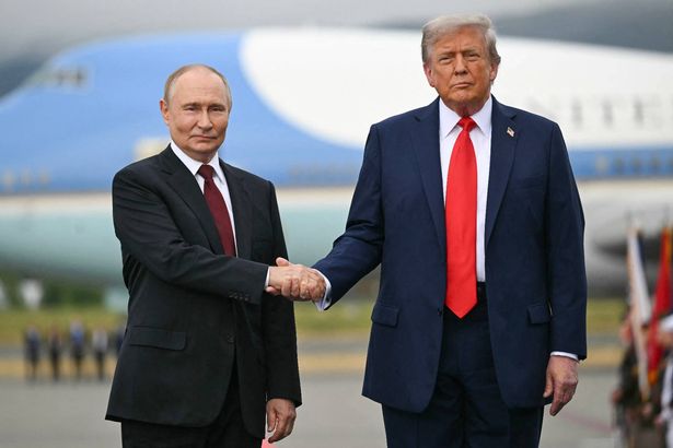 US President Donald Trump greets Russian President Vladimir Putin on the tarmac after they arrived at Joint Base Elmendorf-Richardson in Anchorage, Alaska, on August 15, 2025