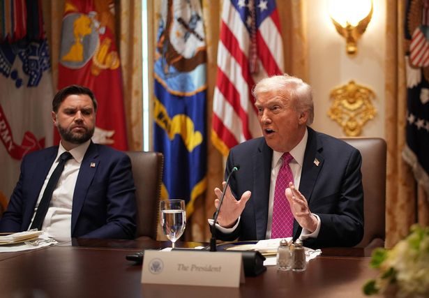 U.S. Vice President JD Vance (L) looks on as U.S. President Donald Trump speaks during a lunch meeting with Ukrainian President Volodymyr Zelensky at the White House on October 17, 2025, in Washington, DC