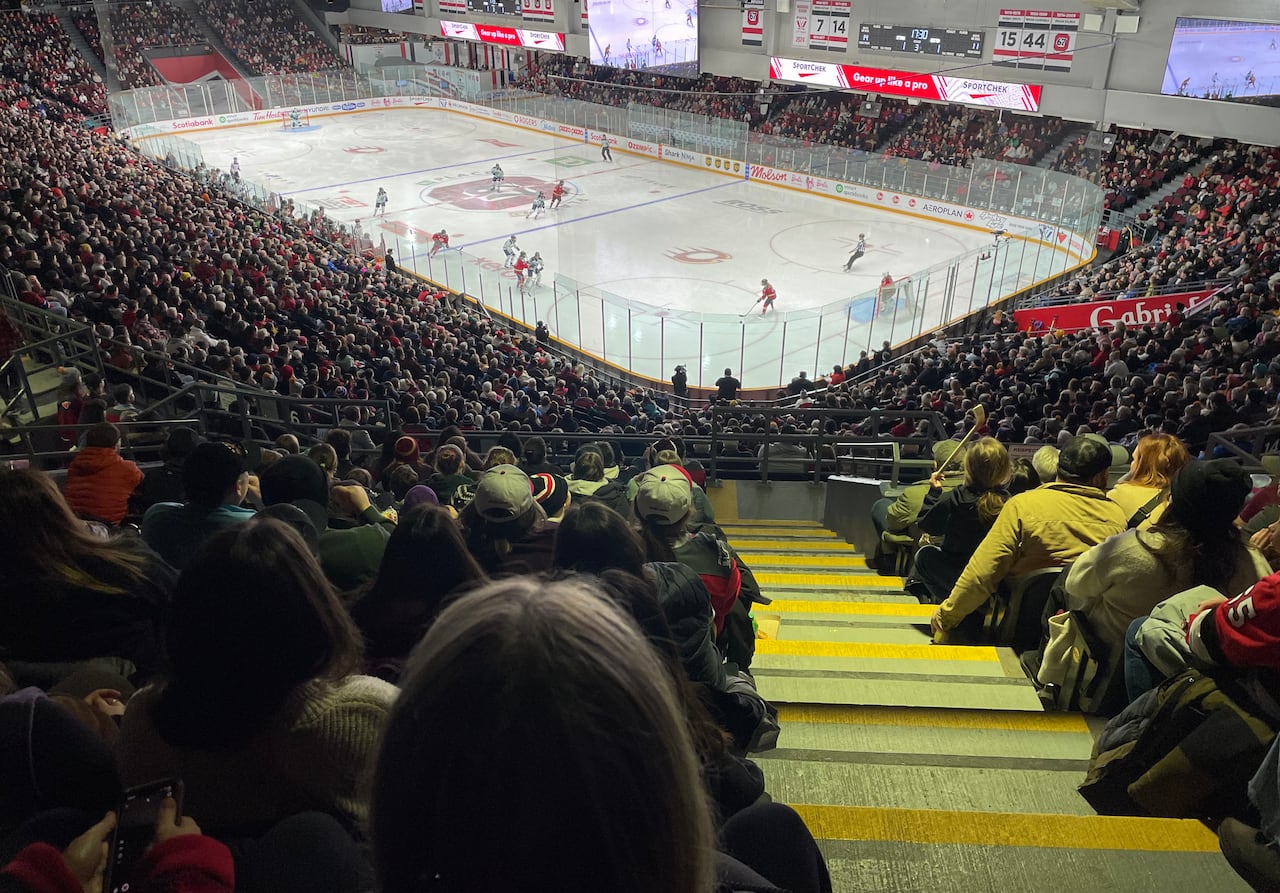 A full arena watches a hockey game.