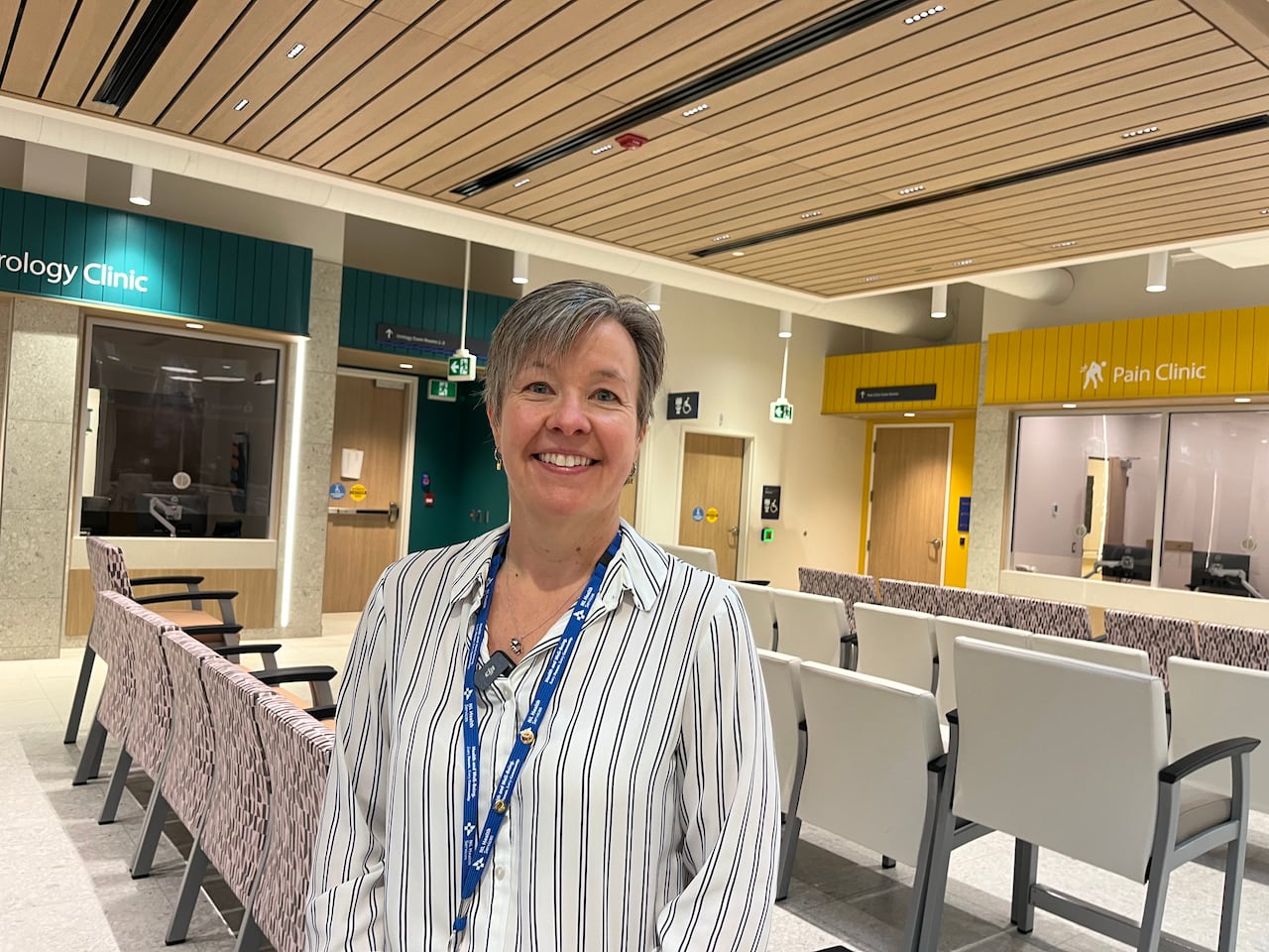 Woman smiles for picture in health care facility waiting room