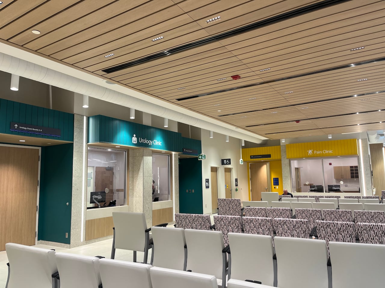 Dozens of chairs in a row in a colorful waiting room